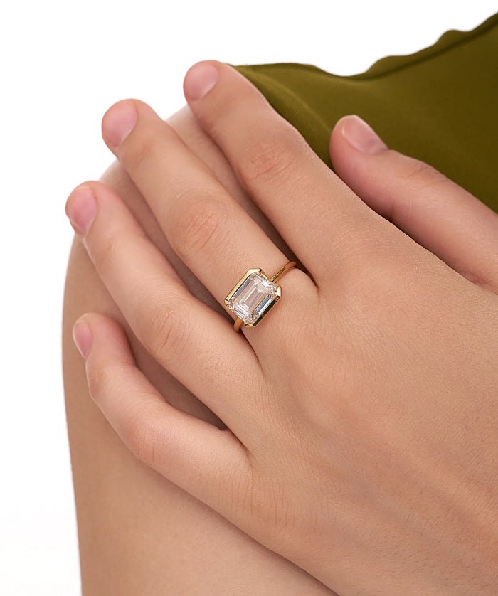East West Emerald Cut Lab Grown Diamond Half Bezel Solitaire Ring in Gold